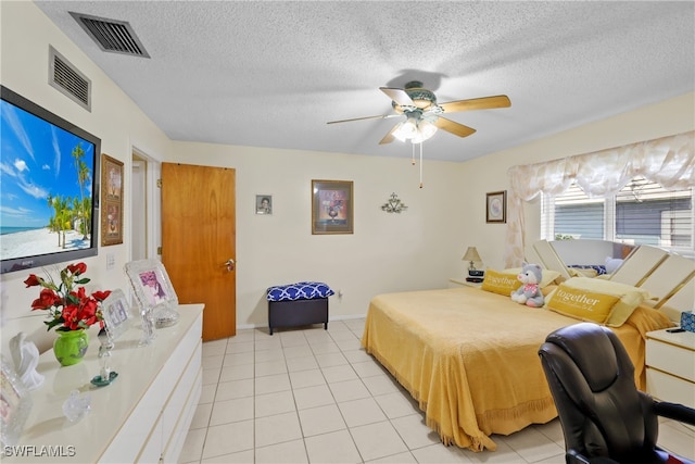 tiled bedroom with a textured ceiling and ceiling fan