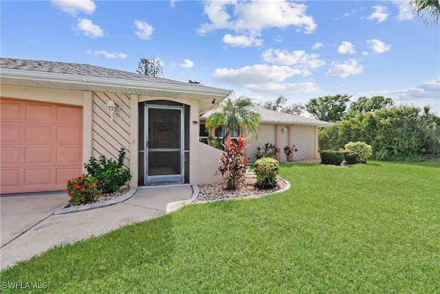 doorway to property featuring a garage and a lawn