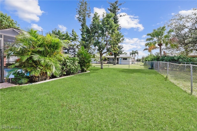 view of yard featuring glass enclosure