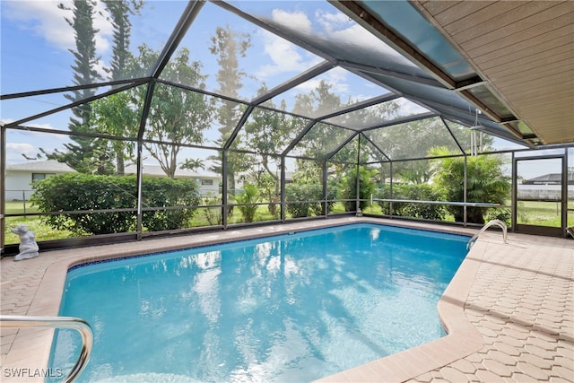 view of swimming pool with glass enclosure