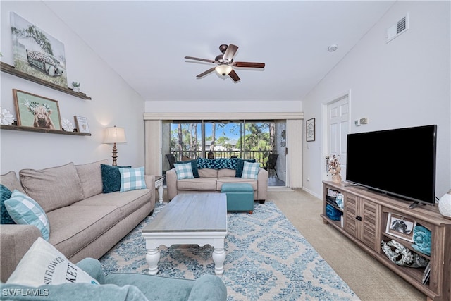 living room with light colored carpet, vaulted ceiling, and ceiling fan