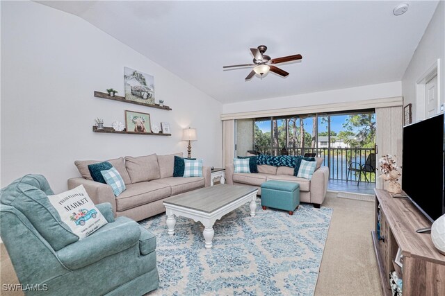 living room featuring light colored carpet, vaulted ceiling, and ceiling fan