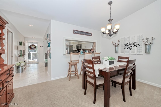 dining room featuring light carpet and a notable chandelier