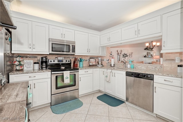 kitchen with stainless steel appliances and white cabinets