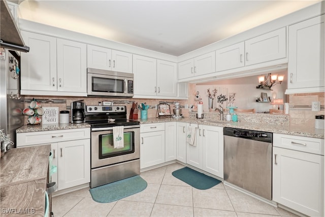 1140 Sarah Jean Cir Unit C-205, Naples, FL 34110 - kitchen with light tile patterned floors, a sink, white cabinetry, decorative backsplash, and appliances with stainless steel finishes