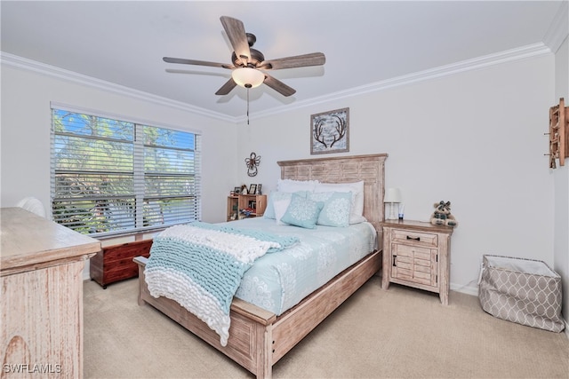 carpeted bedroom with ornamental molding and ceiling fan