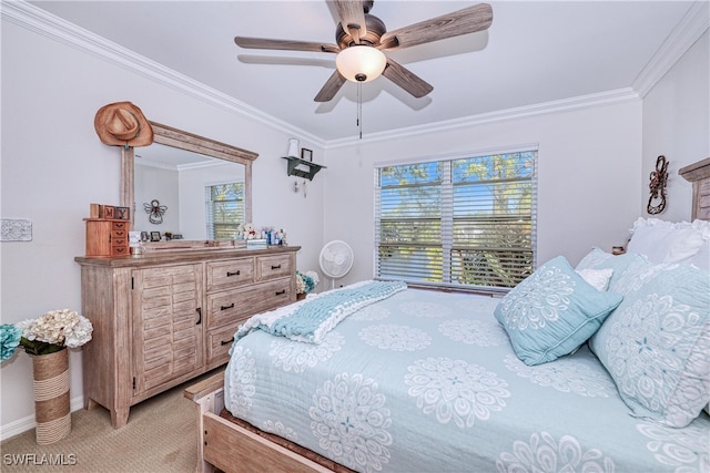 carpeted bedroom with crown molding and ceiling fan