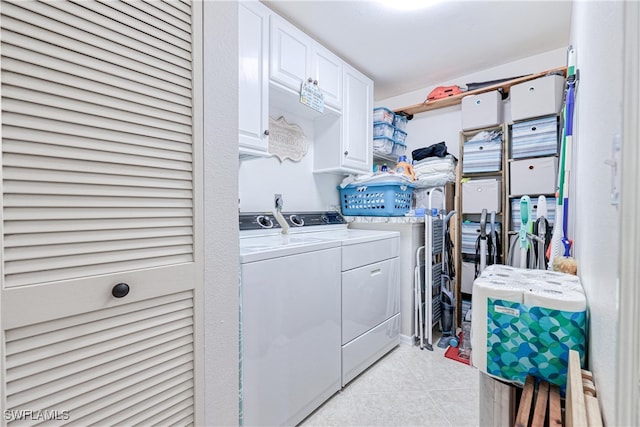 washroom featuring separate washer and dryer, cabinets, and light tile patterned flooring