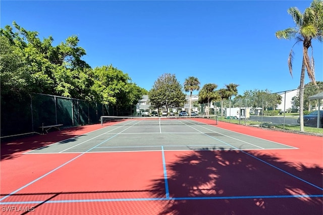 view of tennis court with basketball hoop