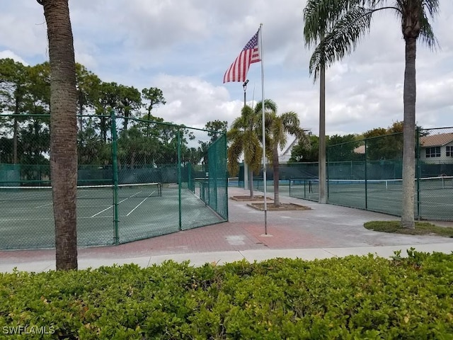 view of tennis court featuring fence