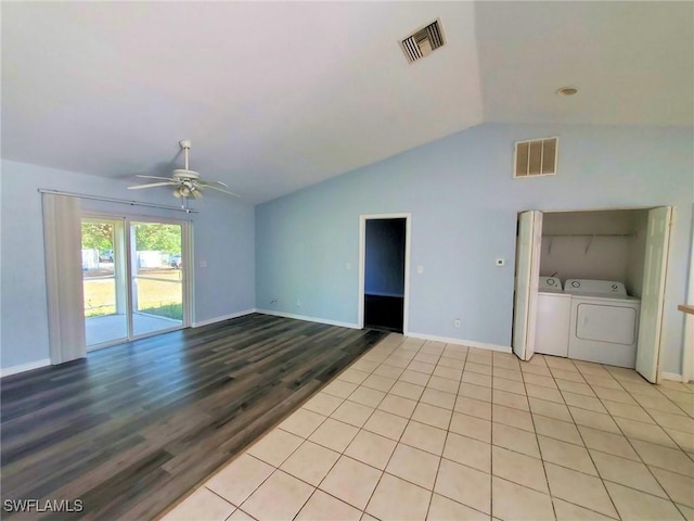 unfurnished living room with light hardwood / wood-style flooring, vaulted ceiling, washing machine and dryer, and ceiling fan