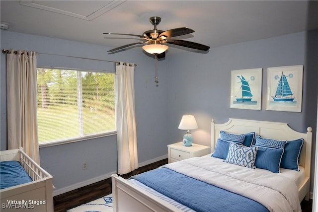 bedroom with ceiling fan and dark hardwood / wood-style floors