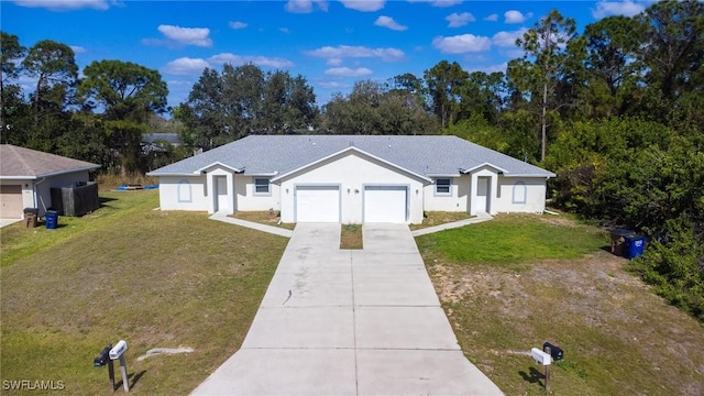 single story home featuring a garage and a front yard