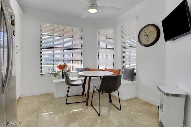 dining room with ceiling fan and ornamental molding