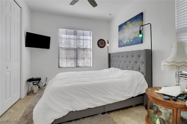 bedroom featuring ceiling fan and a closet