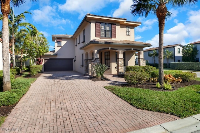 mediterranean / spanish home featuring a porch and a garage