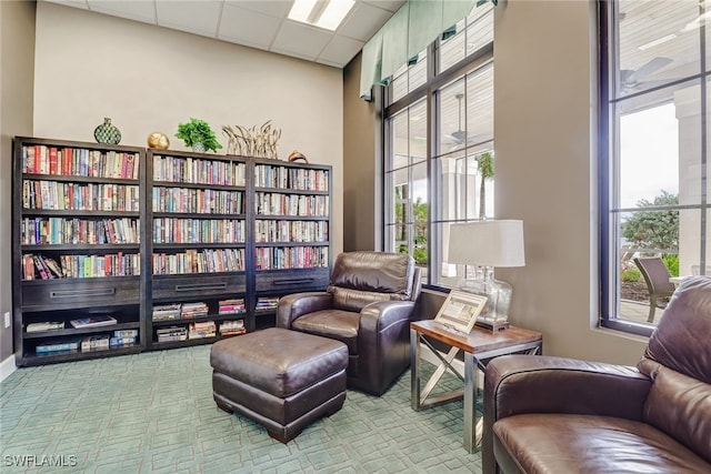 living area with a paneled ceiling