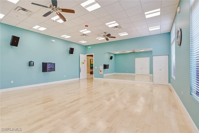 spare room featuring a paneled ceiling and light wood-type flooring