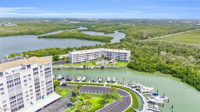 birds eye view of property with a view of trees and a water view