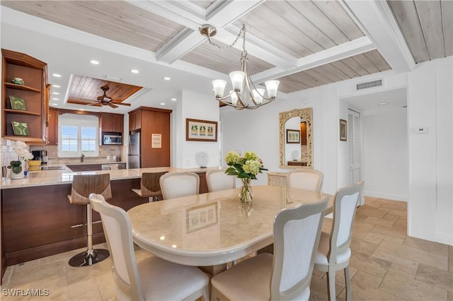 dining room featuring ceiling fan with notable chandelier, crown molding, and beamed ceiling