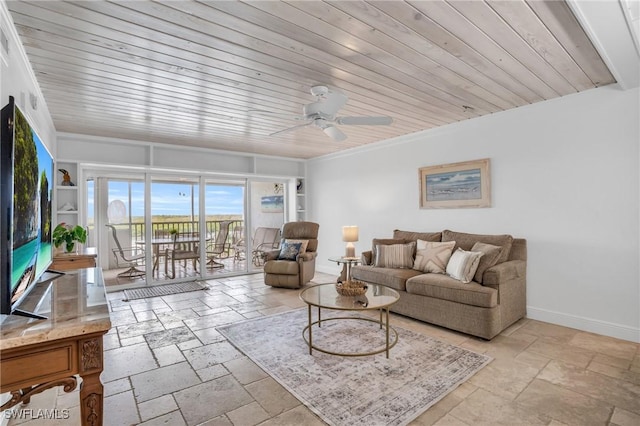 living area with stone tile floors, ceiling fan, wooden ceiling, baseboards, and ornamental molding