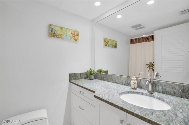 bathroom with visible vents, recessed lighting, vanity, and toilet