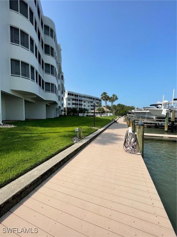 dock area featuring a yard and a water view