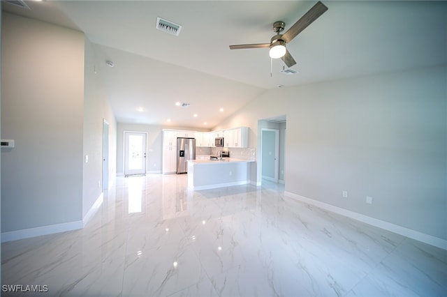 unfurnished living room with ceiling fan and lofted ceiling