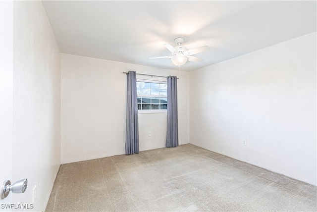 empty room with carpet floors and ceiling fan