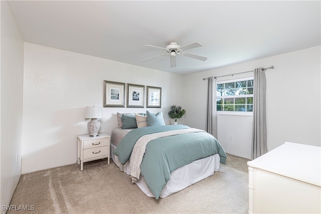 bedroom featuring ceiling fan and light carpet