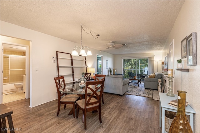 dining area with ceiling fan with notable chandelier, dark hardwood / wood-style flooring, and a textured ceiling