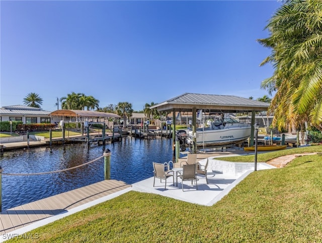 view of dock with a yard and a water view