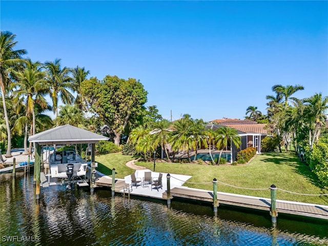 dock area with a water view and a yard