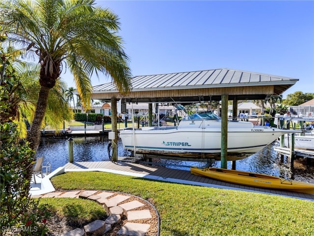 dock area with a yard and a water view