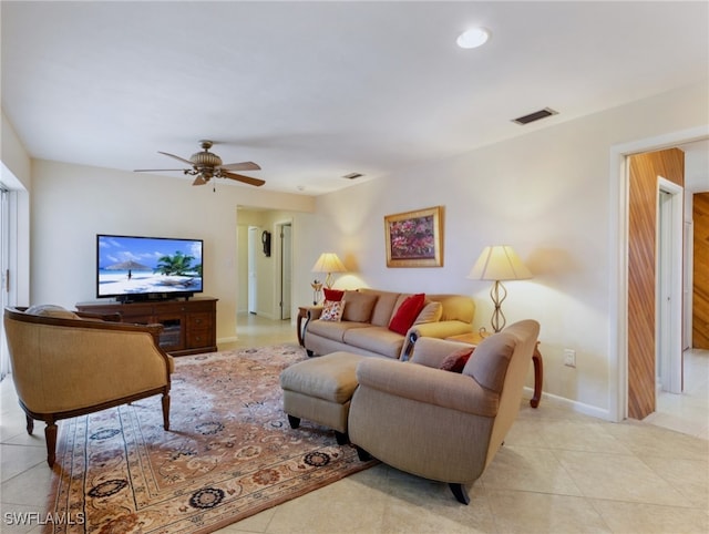 tiled living room with ceiling fan