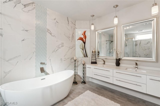 bathroom with vanity, hardwood / wood-style flooring, tile walls, and independent shower and bath