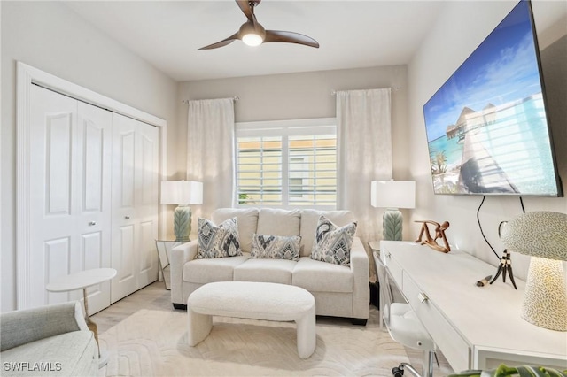 living room with ceiling fan and light wood-type flooring