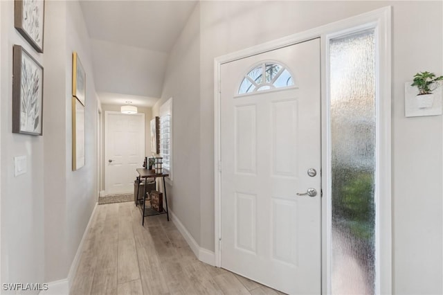 foyer featuring light wood-style flooring and baseboards