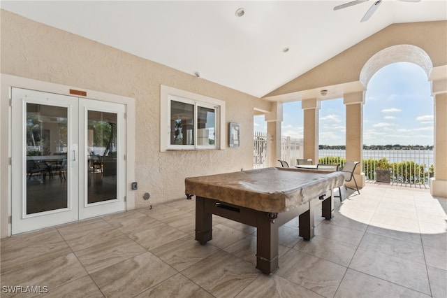 view of patio / terrace featuring ceiling fan, a water view, and french doors