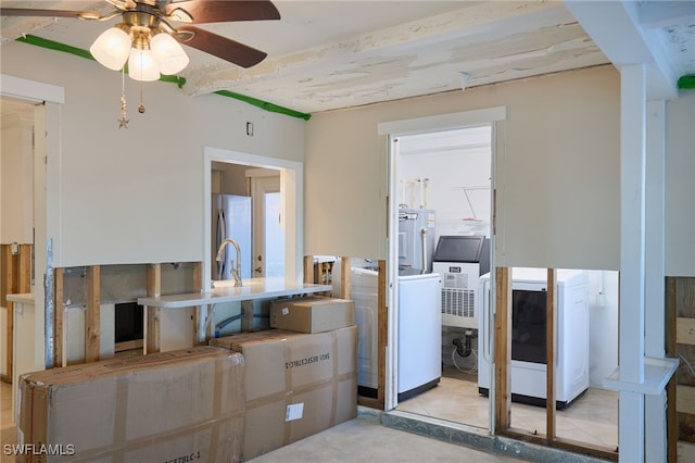 interior space featuring ceiling fan, stainless steel refrigerator, electric water heater, and washer / clothes dryer