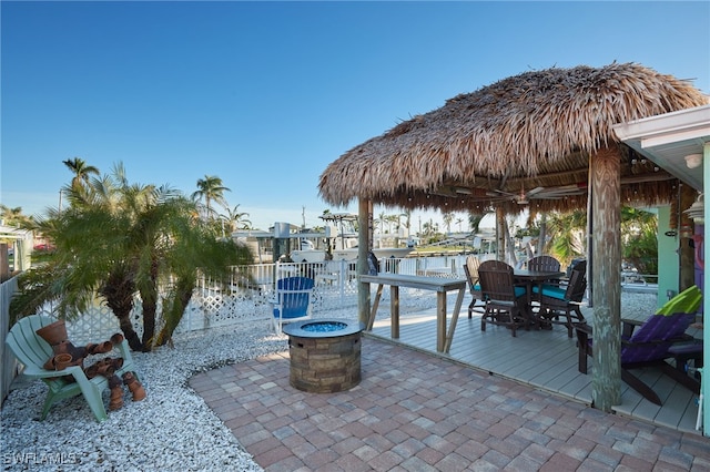 view of dock featuring a deck with water view and an outdoor fire pit