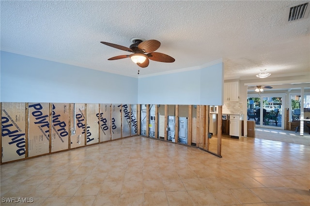 empty room with ceiling fan, light tile patterned flooring, ornamental molding, and a textured ceiling