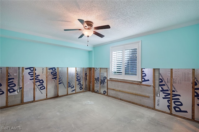 unfurnished room with ceiling fan, concrete flooring, a textured ceiling, and ornamental molding