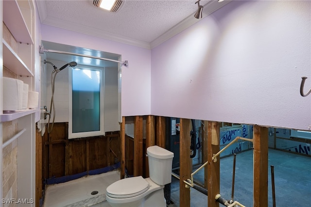 bathroom featuring ornamental molding, a textured ceiling, wooden walls, a shower, and toilet