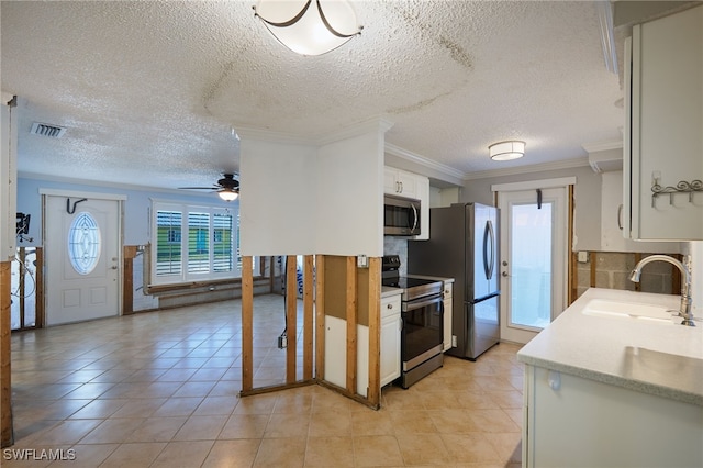 kitchen featuring white cabinetry, sink, ceiling fan, stainless steel appliances, and tasteful backsplash