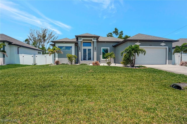 view of front of property featuring a garage and a front lawn