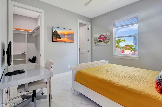 bedroom with ceiling fan and a closet