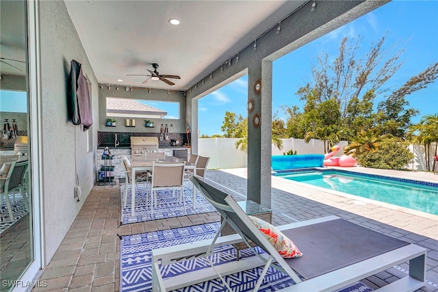 view of patio / terrace with grilling area, a fenced in pool, area for grilling, and ceiling fan