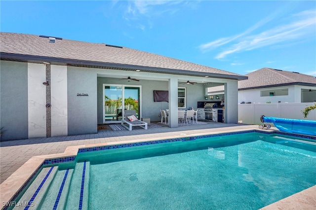 view of pool with area for grilling, ceiling fan, exterior kitchen, and a patio