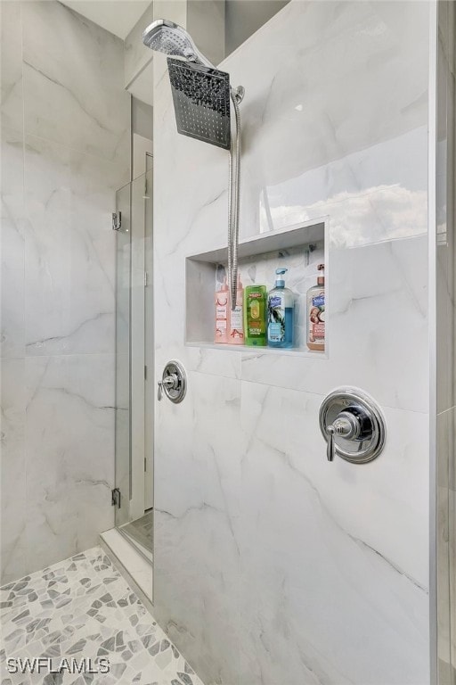 bathroom with a shower with shower door